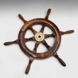 A hardwood and brass mounted ship's wheel, with six turned square section spokes. Diameter 56cm.