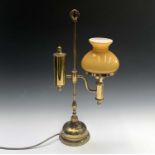 An early 20th century student's oil lamp with amber glass shade, converted for electricity. Height