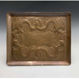 A Newlyn Industrial Class tray of rectangular form, repousse decorated with dragons. 38cm x 46cm.