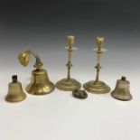 A brass bell, height 14cm overall, a near pair of smaller brass bells, and a pair of Victorian brass