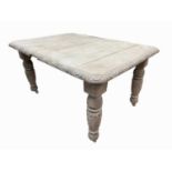 A late Victorian bleached oak dining table, raised on leaf carved turned legs, height 74cm, width