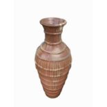 A large terracotta jar with banded decoration. Height 100cm.