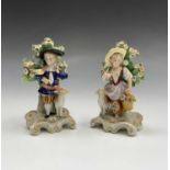 A pair of continental porcelain figures of a young shepherd and shepherdess, circa 1900. Height