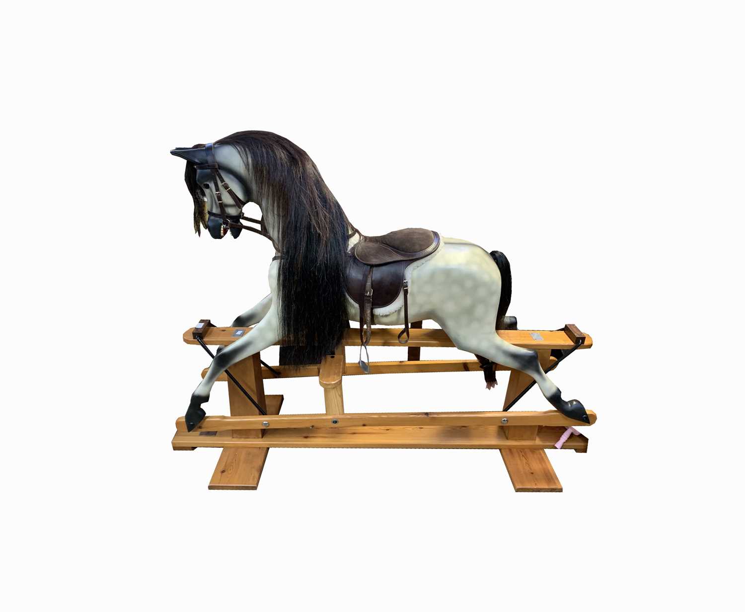 A rocking horse on a pine stand, dapple grey, bearing plaque inscribed 'Kipper Dobbin'. Length