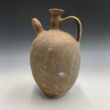 A terracotta spouted jar with handle. Height 35cm.