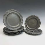 A set of six pewter dinner plates, early 19th century, with raised rims, diameter 23.5cm and four