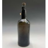 A Georgian wine bottle and contents labelled "Recovered from Wreck of HMS Caroline Sept 1971, sunk