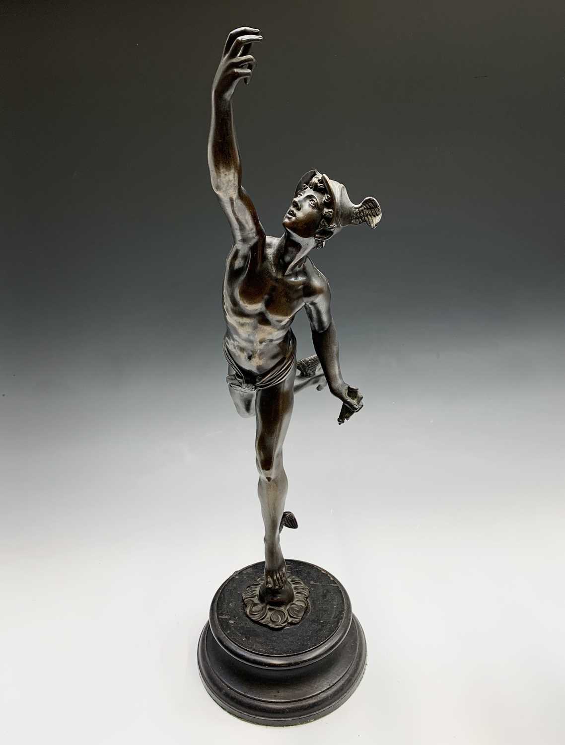 An early 20th century bronze figure of Mercury supported by a zephyr, after Gimbologna, on