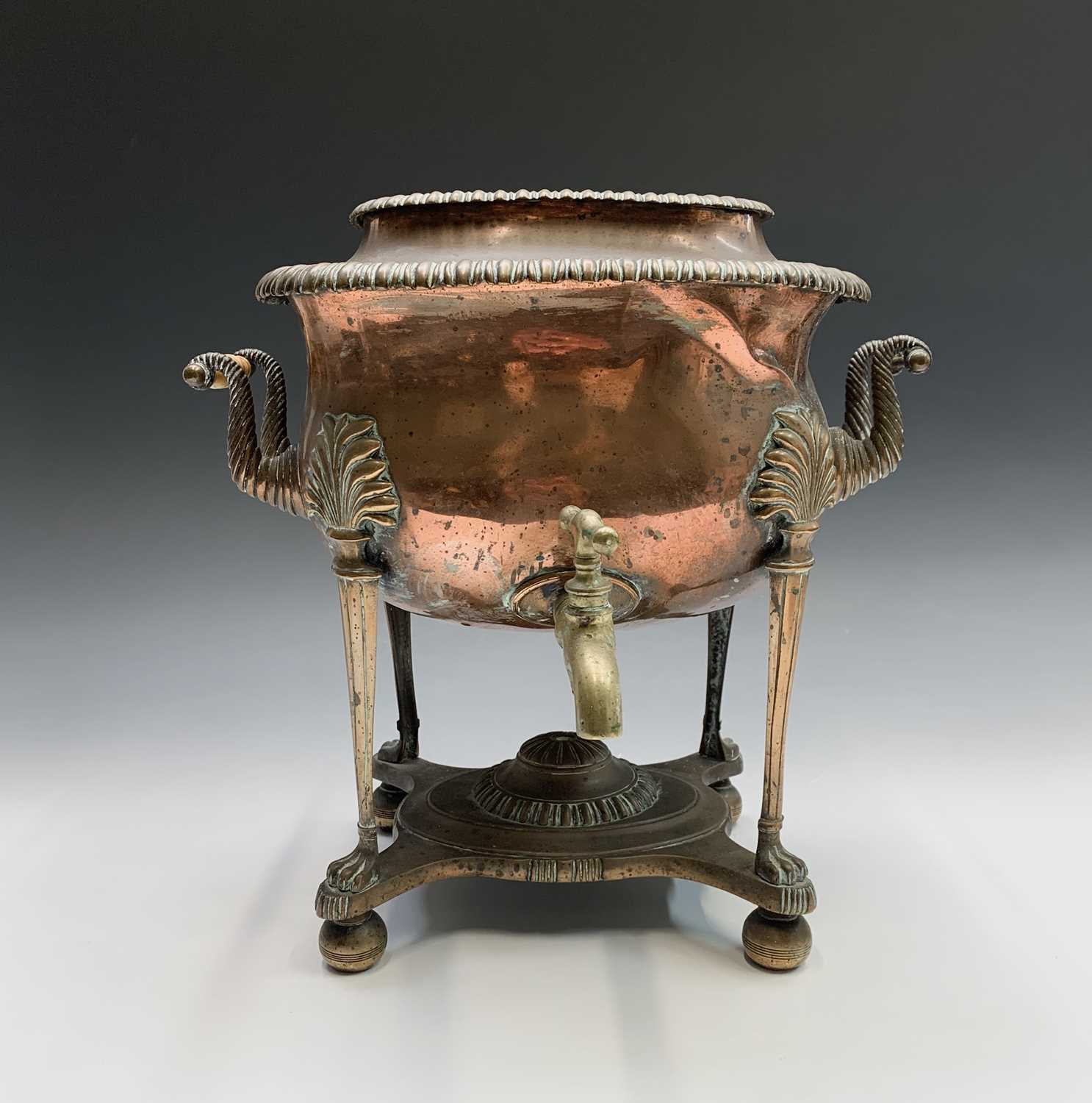 A George III twin handled copper and brass tea urn, the body raised on reeded columns terminating in - Image 2 of 5