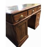 A Victorian pitch pine pedestal desk, with a brass label 'W & THO MAY, TRIUMPH WORKS, SHEFFIELD,