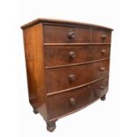 A Victorian mahogany bow front chest of drawers, with two short and three long drawers on bun
