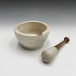 A pestle and mortar. Height of mortar 11cm, length of pestle 22.5cm.