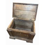 A Continental walnut small chest, 18th century, with lift up lid and panelled front on bracket feet,