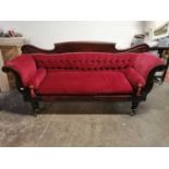 A William IV mahogany scroll end sofa, with button back and loose cushion, on turned tapering