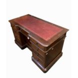 A Victorian mahogany kneehole desk, with inset leather skiver above an arrangement of nine drawers
