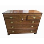 A mahogany chest of drawers, early 19th century, with three short and three long drawers, on