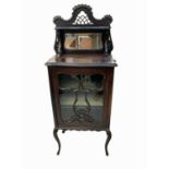 An Edwardian mahogany display cabinet, the glazed door opening to reveal three shelves, on