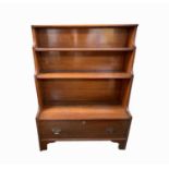 A19th century walnut waterfall bookcase, fitted with three shelves and a lower drawer on bracket