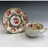 A John Rose Coalport porcelain cup and saucer, circa 1820, painted with floral bouquets, within gilt