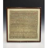 A 19th century sampler worked by Mary Ann Savage, embroidered with the alphabet and numerals,