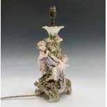 A late 19th/early 20th century Coburg Dresden figural centrepiece modelled with putti amongst