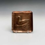 A Newlyn Industrial Class copper pin tray, repousse decorated with a seagull. 10.5cm x 10.5cm.
