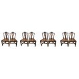 A set of eight George III country made dining chairs, each with a pierced splat and solid seat on