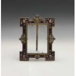 A good 19th century champleve enamel easel picture frame, with pierced scroll decoration and reel
