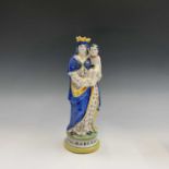 A French tinglazed figure, late 19th century, polychrome decorated, inscribed 'St Marie' and