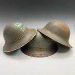 Three Second World War A.R.P helmets.