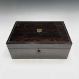 A 19th century coromandel and brass inlaid writing slope, with shield shape cartouche to lid, with