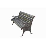 A slatted garden bench, with cast iron ends, decorated with flowers and foliage. Width 148cm.