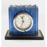 A French Art Deco blue glass mantel timepiece, with vertical ribbed decoration moulded with flowers,