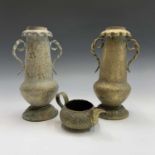 A pair of 19th Century Indian brass twin handled vases, with engraved decoration, height 31cm and