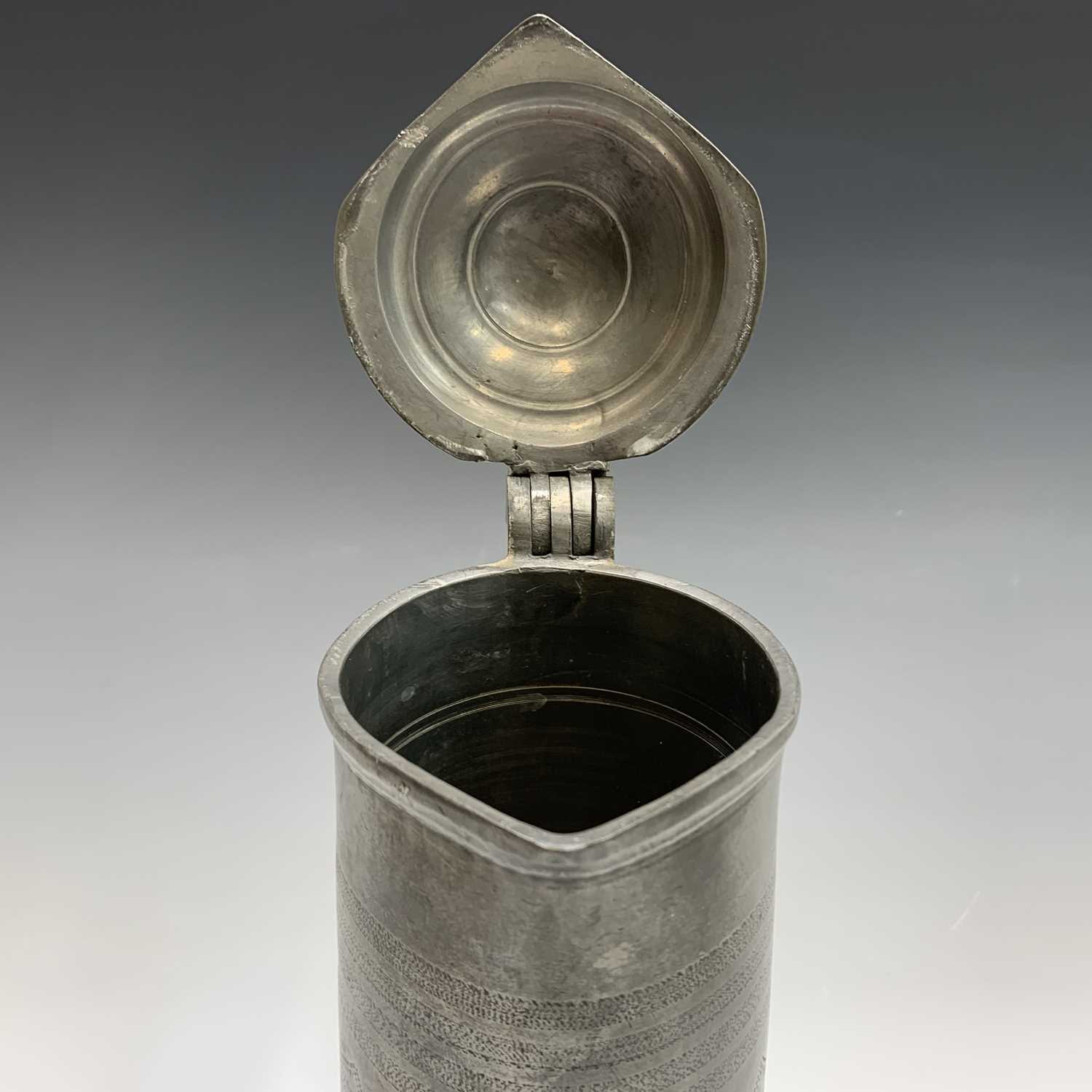 A 19th century pewter flagon with hinged cover, engraved with tulips and initialled G.A.K. and dated - Image 4 of 20
