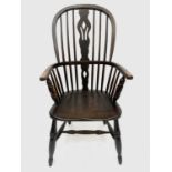 A 19th century ash and elm Windsor elbow chair, with pierced vase splat, solid seat and turned legs,