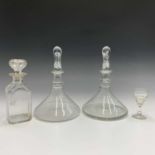 A pair of ships glass decanters and later stoppers, height 28cm, another decanter and stopper and