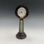 An early 20th century Cornish serpentine desk clock, the annular top inset a later clock movement,