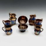 A collection of eleven Victorian copper lustre jugs and two bowls (13).