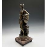Ferdinand Barbedienne after Claude Michel Clodion. A bronze figure of a maiden standing next to an