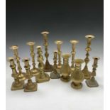 An assortment of Victorian and later brass candlesticks and a pair of Victorian brass ecclesiastical