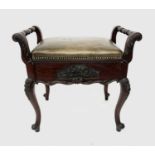 A Victorian mahogany piano stool, with a lift up padded seat, on carved cabriole legs, height