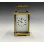 A French brass cased carriage timepiece, circa 1900. Height 12cm.