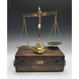 A set of 19th century brass beam scales, contained in an oak fitted travel case, by S Banfield,