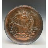 An Arts and Crafts period copper charger, repousse decorated with a galleon, unmarked. Diameter 36.