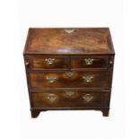 A George III mahogany bureau, with a fall front and fitted interior above two short and two long