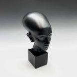 Danish design - A black painted plaster negro bust, raised on a square plinth base. Height 27cm.