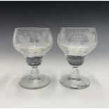 A pair of cut glass rummers, circa 1920, with etched vine and grape decoration, on baluster stems.