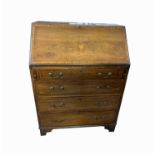 An Edwardian mahogany bureau, the inlaid fall front above four long drawers on bracket feet,