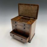 A mid Victorian burr walnut cigar cabinet fashioned as a chest with four long drawers, the hinged